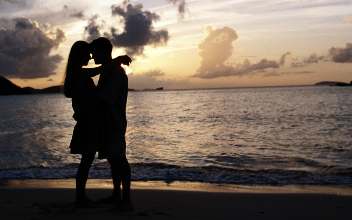 Glückliches Paar in einer langen Beziehung am Strand bei Sonnenuntergang